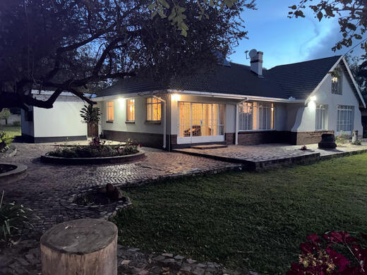 Night image of Orana Guest House from garden