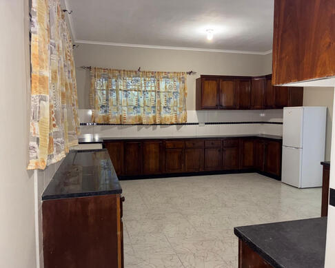 Orana Guest House modern kitchen facility with ample storage and fridge freezer